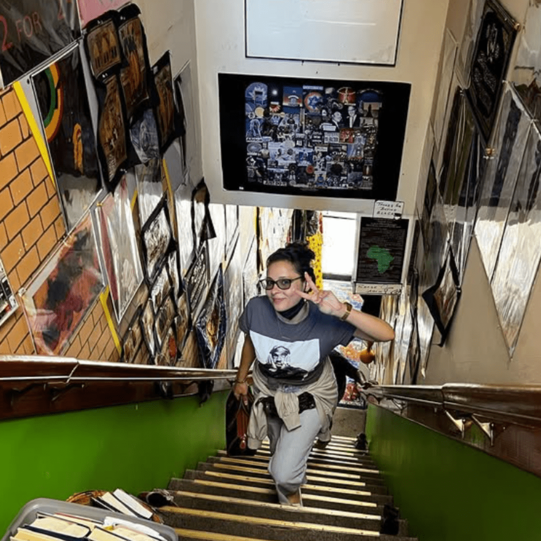 Person ascending colorful staircase with art
