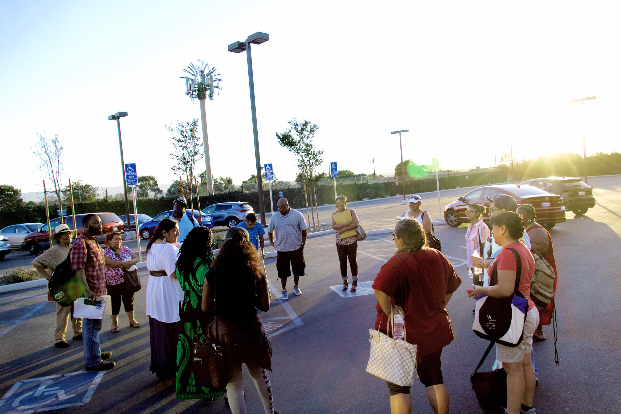 Community members gathered outdoors for a group discussion